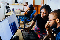 people looking at a computer